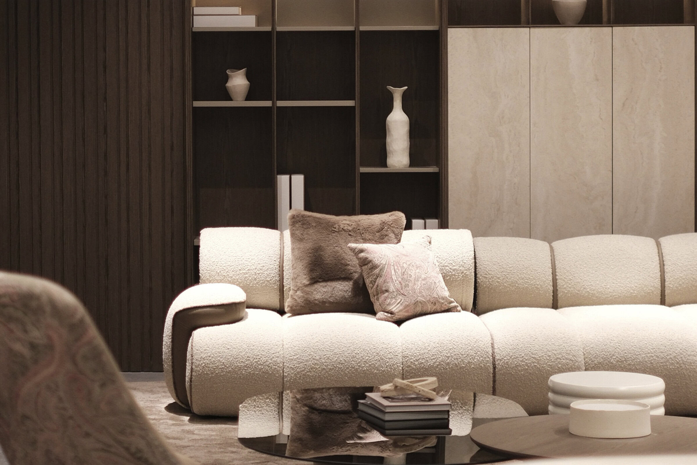 Luxurious cream-colored sectional sofa with plush throw pillows in a modern living room setting, featuring elegant wooden wall paneling and contemporary decor.
