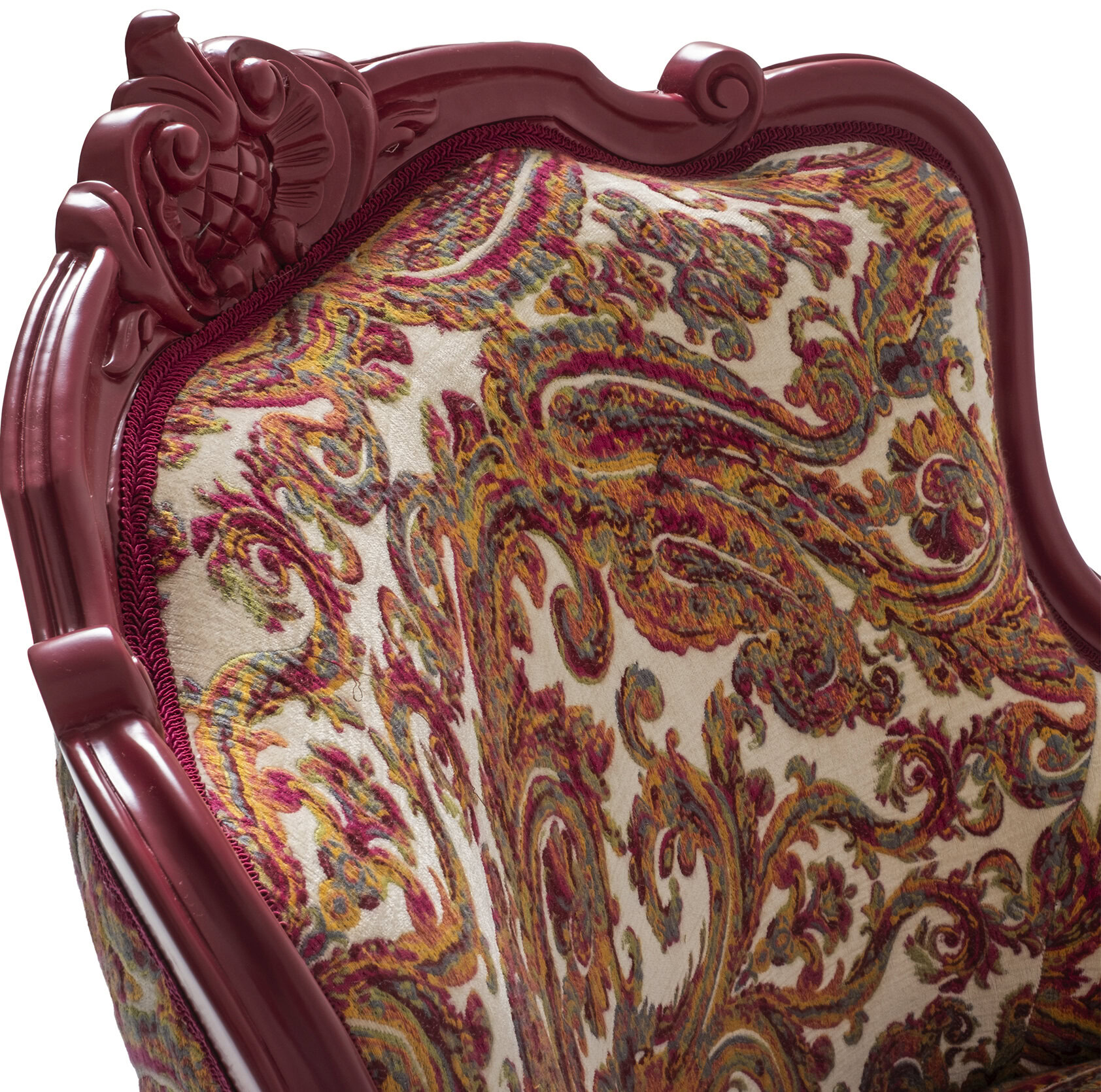 Ornate vintage wooden armchair with intricate carving and colorful embroidered fabric upholstery, perfect for luxurious and classic living room decor.