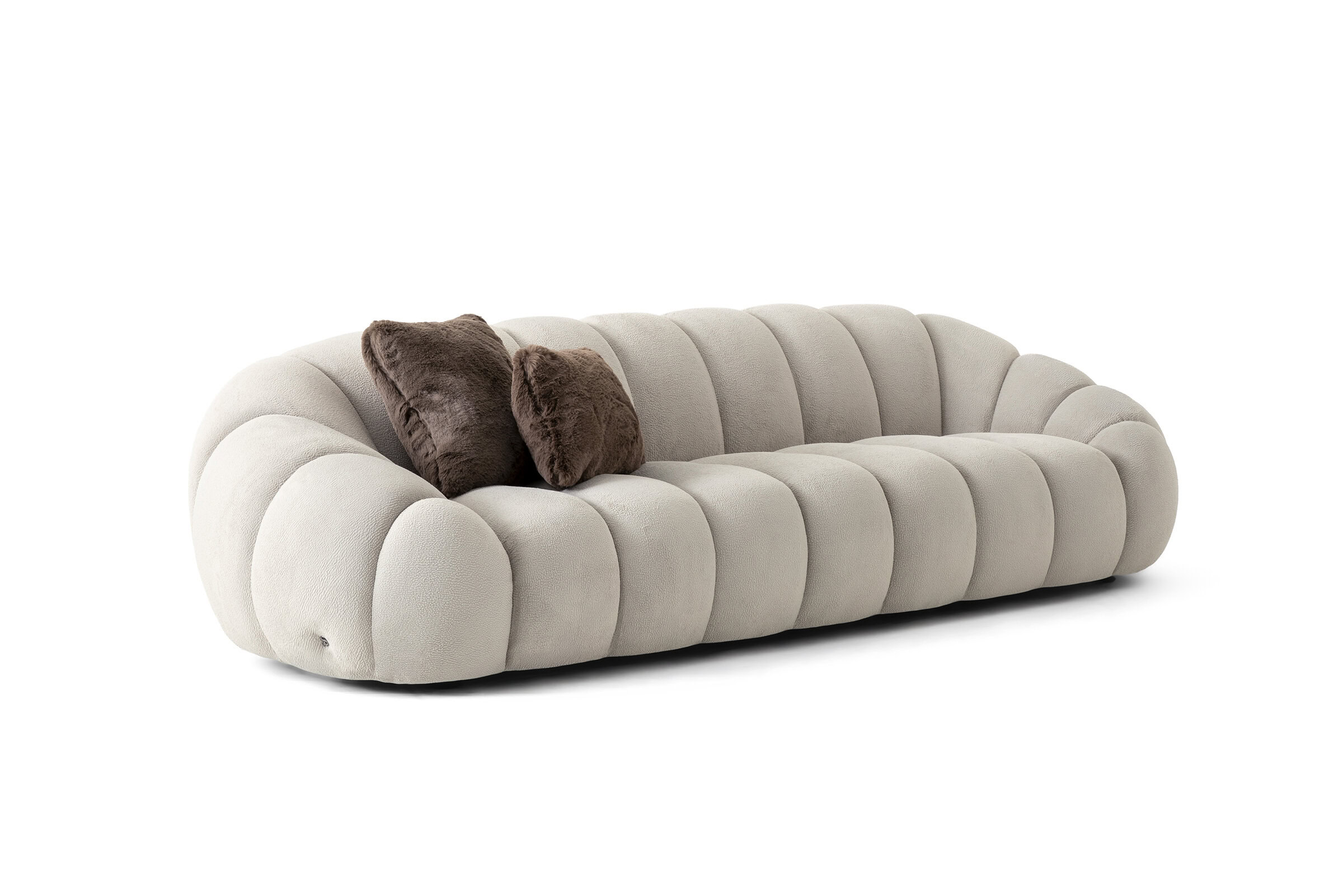 Canapea elegantă, bej, din pluș, cu design rotunjit și două perne maro, ideală pentru decorul contemporan al camerei de zi.