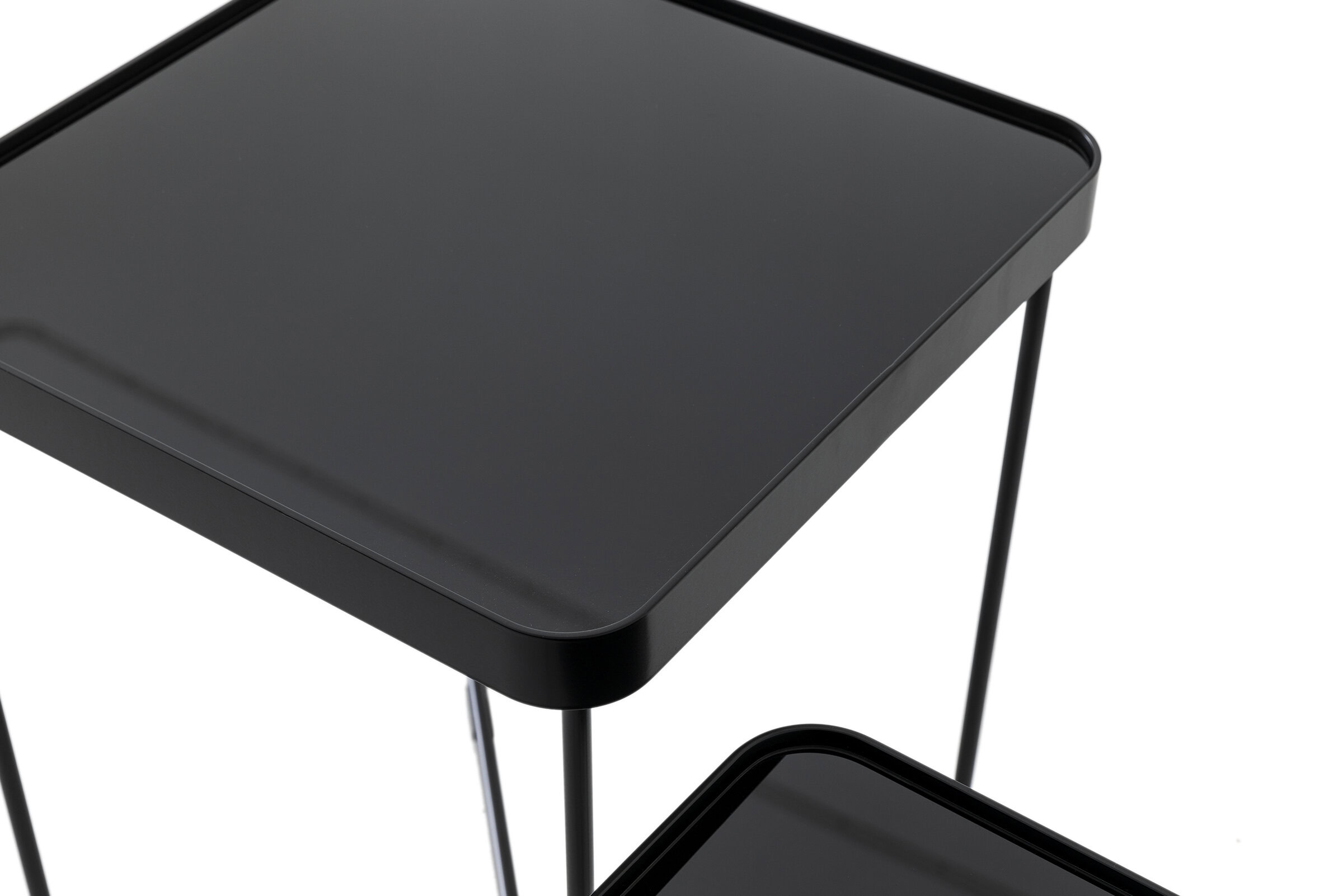 Sleek black modern side table with minimalist design, metal frame, and smooth surface for stylish home decor and furniture solutions.