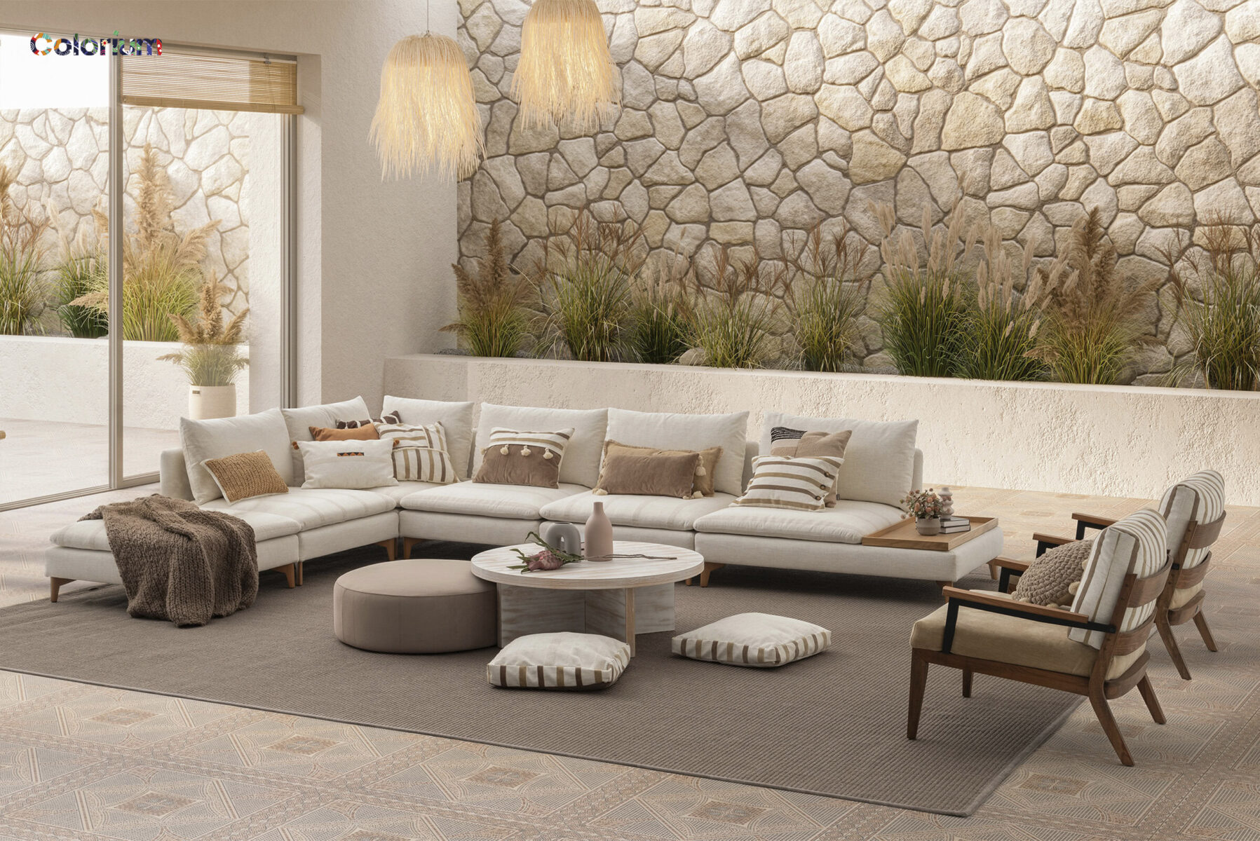Stylish living room featuring a large white sectional sofa, cozy armchairs, and decorative cushions, complemented by natural stone wall accents and lush indoor plants for a warm, inviting atmosphere.