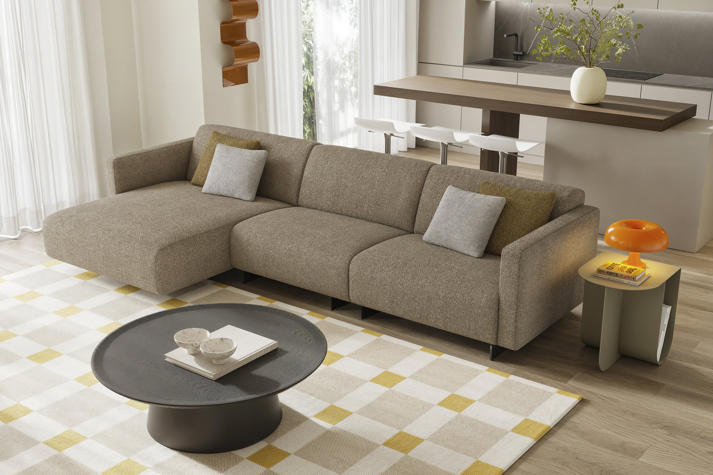 Contemporary beige sectional sofa with decorative pillows in a modern living room setting featuring neutral tones and minimalist design.