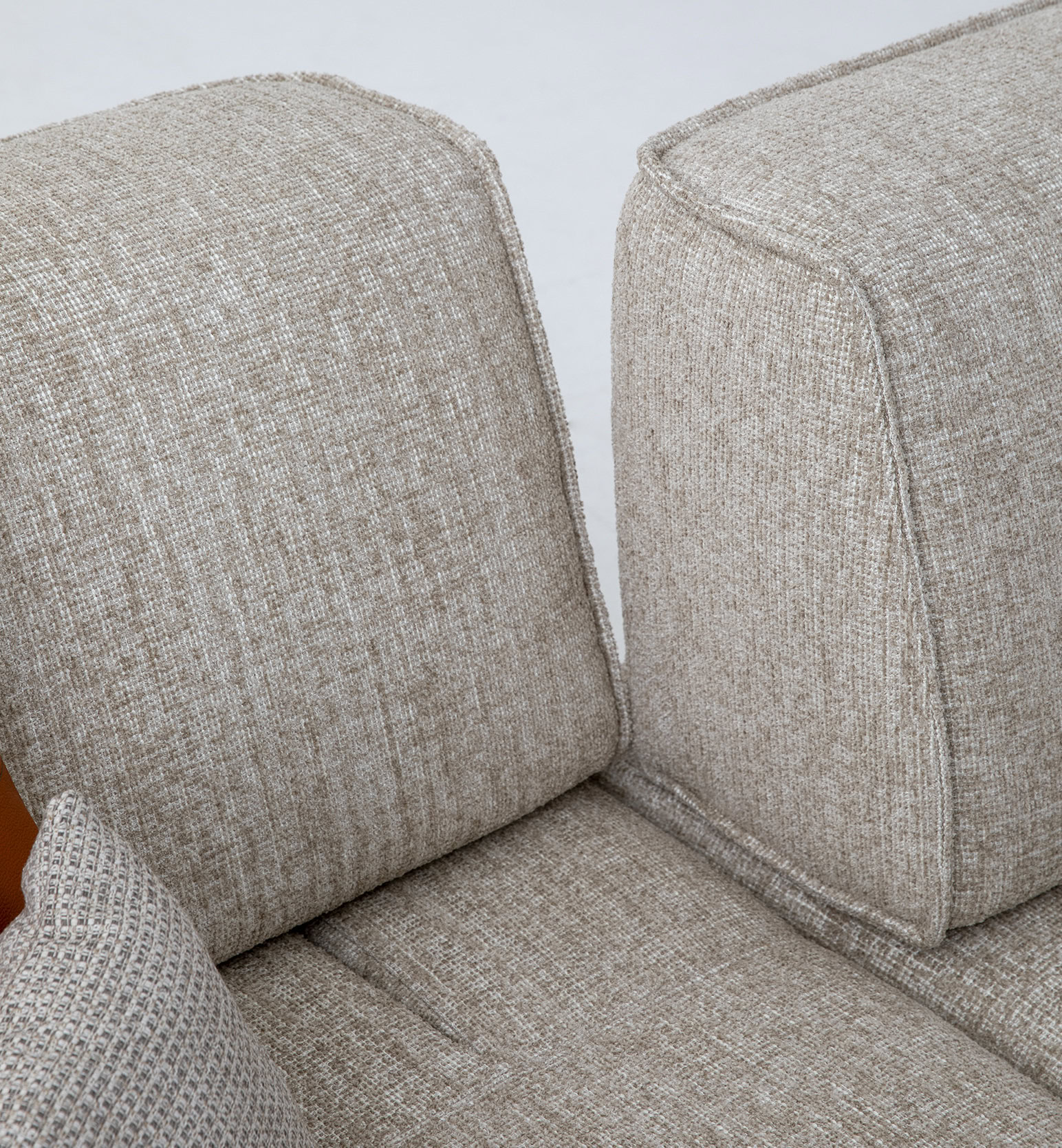 Contemporary beige fabric sofa with plush cushions and durable upholstery, perfect for living rooms seeking stylish comfort and quality furniture.