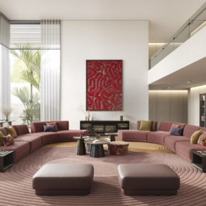 Luxurious modern living room with a curved pink sofa, colorful cushions, a large abstract red artwork on white wall, and floor-to-ceiling windows with natural light, creating a stylish and cozy ambiance.