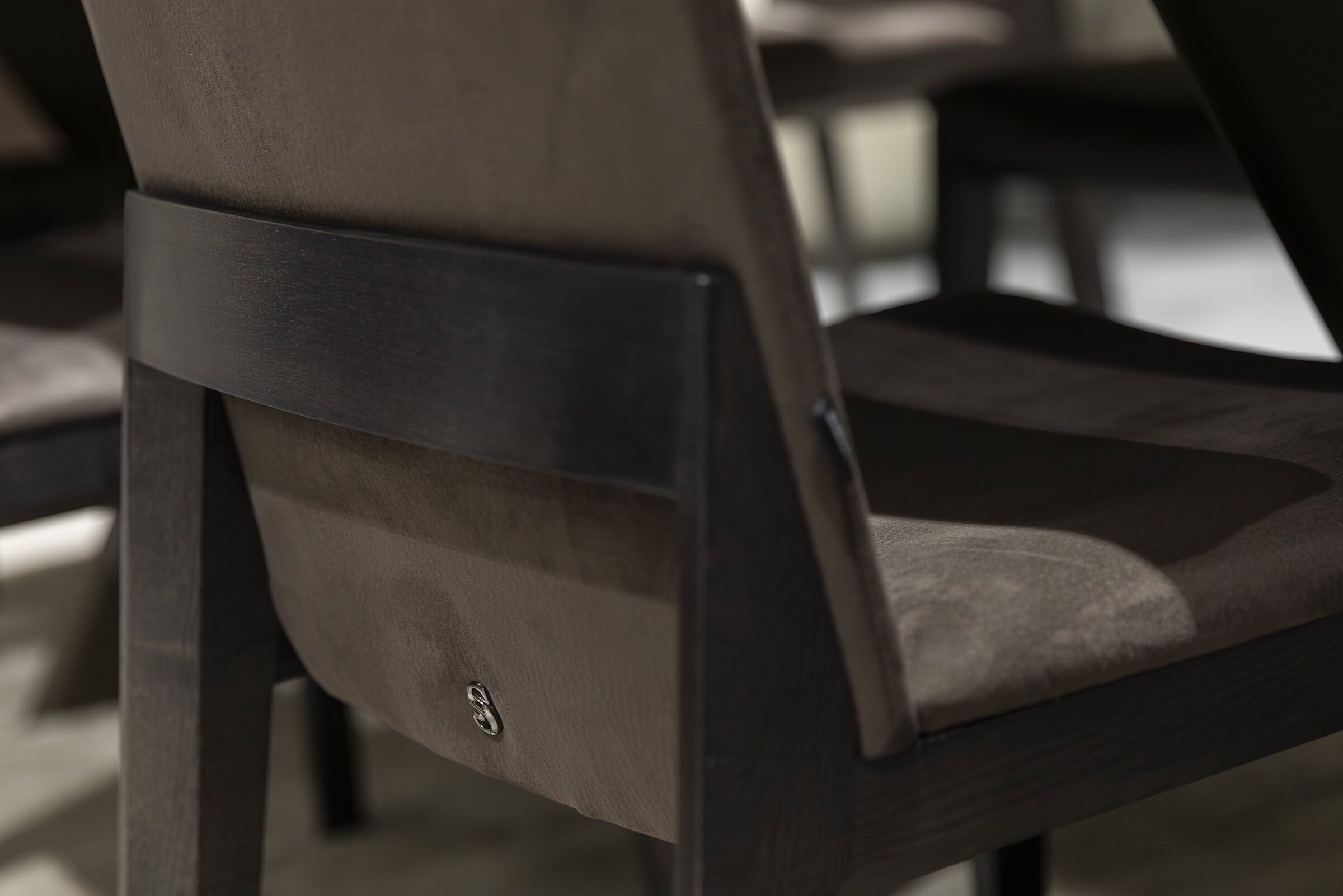 Sleek wooden dining chair with a dark stain finish, showcasing modern furniture design and craftsmanship. Perfect for contemporary dining spaces.