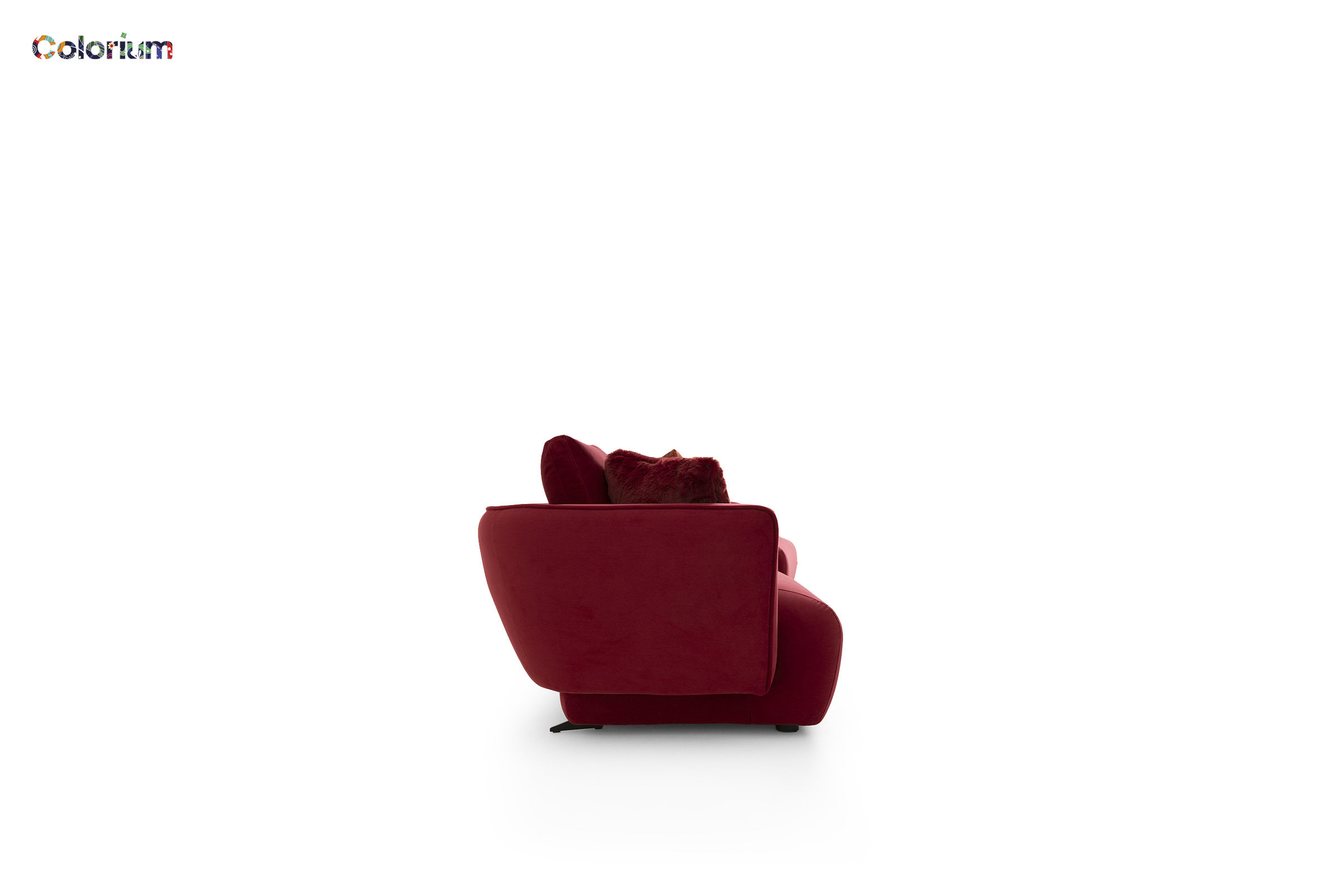 Stylish red armchair with plush cushions, perfect for contemporary living room interiors, offering comfort and vibrant color.