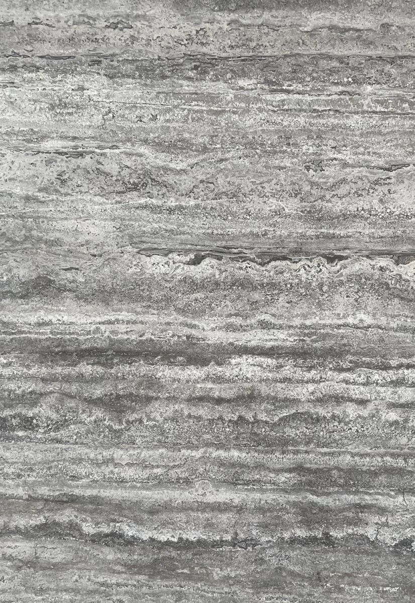Close-up of a textured grey concrete wall surface, showcasing natural patterns and rough finish, ideal for modern interior or exterior design projects.