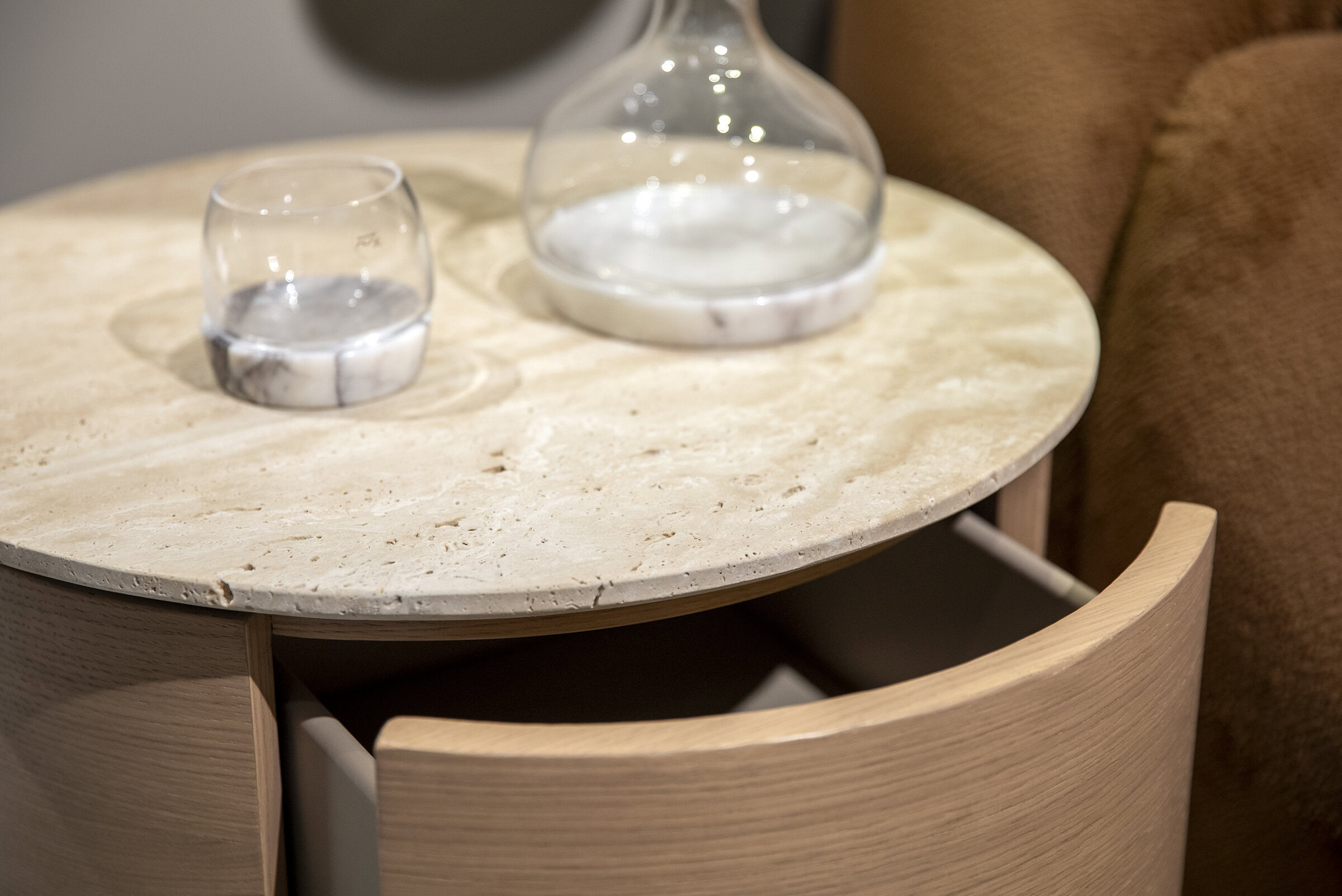 Sleek beige marble side table with natural wood accents, perfect for modern living room decor; features a spacious drawer for storage.