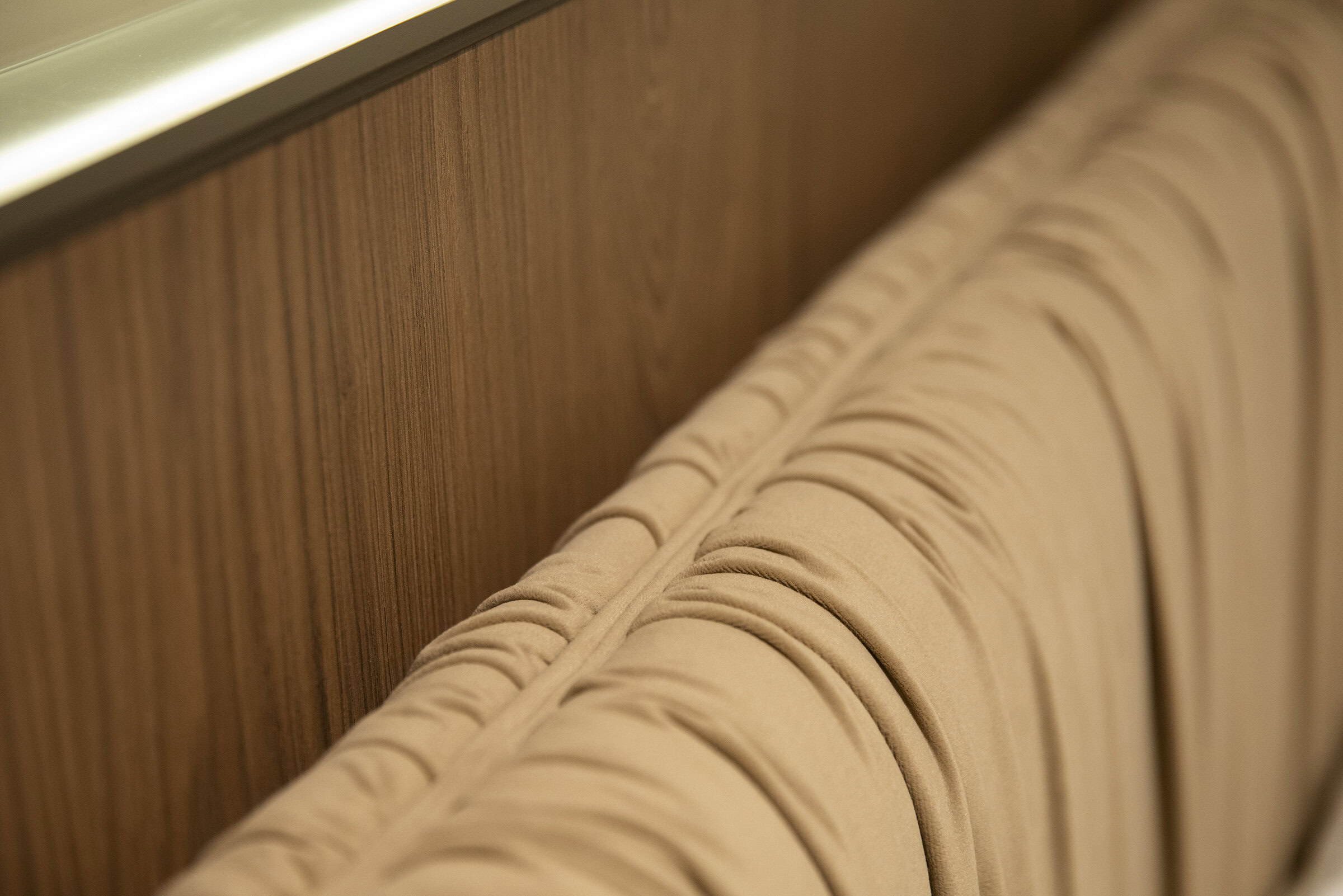 Elegant wooden headboard with beige upholstered padding, showcasing premium furniture design and craftsmanship. Ideal for modern bedroom decor.