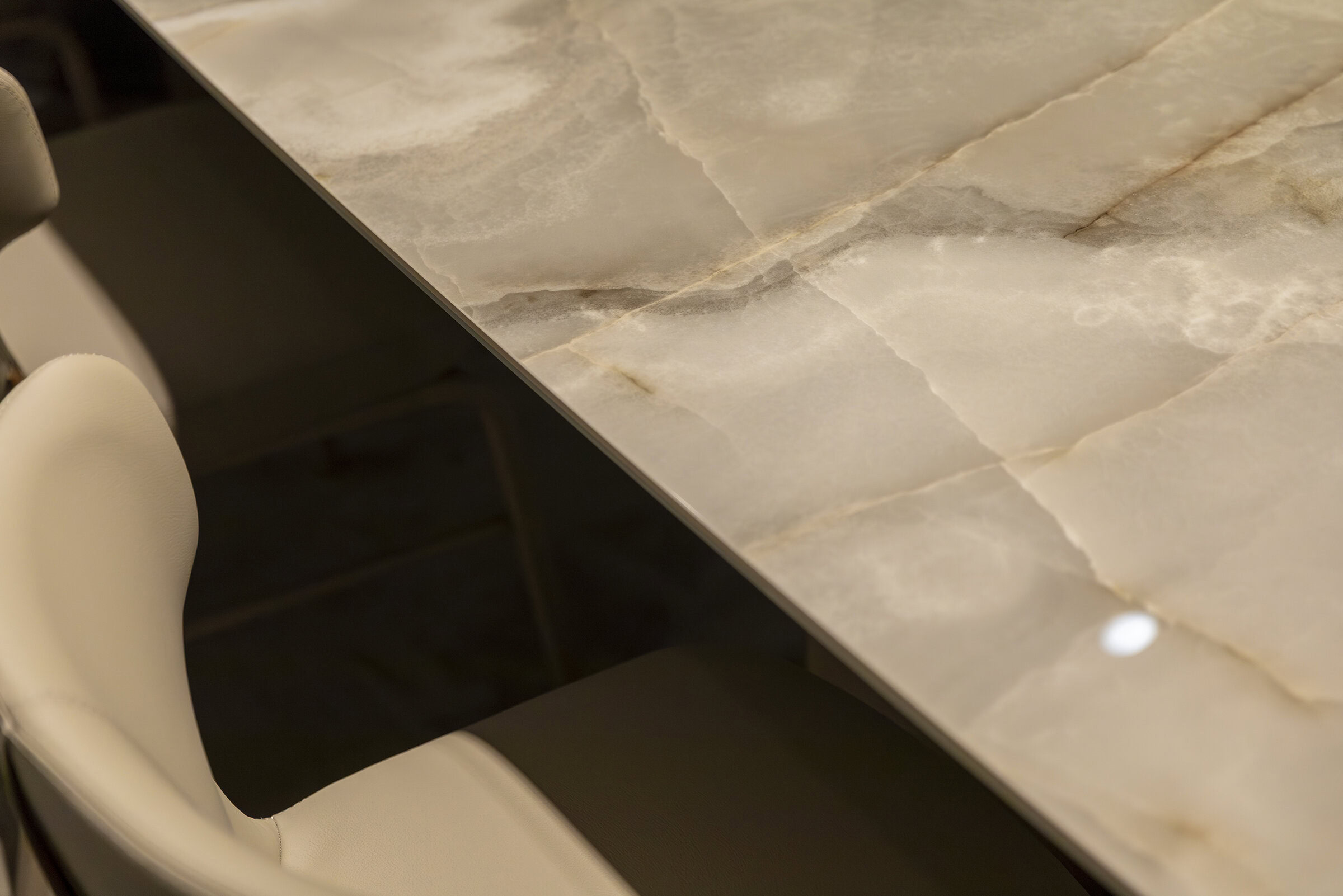 Luxurious marble-topped dining table with elegant veining and polished surface, ideal for modern and sophisticated homes or upscale interiors.