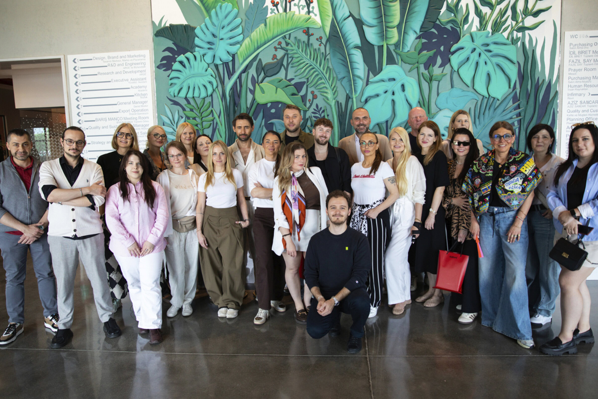 Group of diverse professionals and visitors at the Saloni Furniture exhibition, showcasing modern furniture designs and innovative interior solutions.