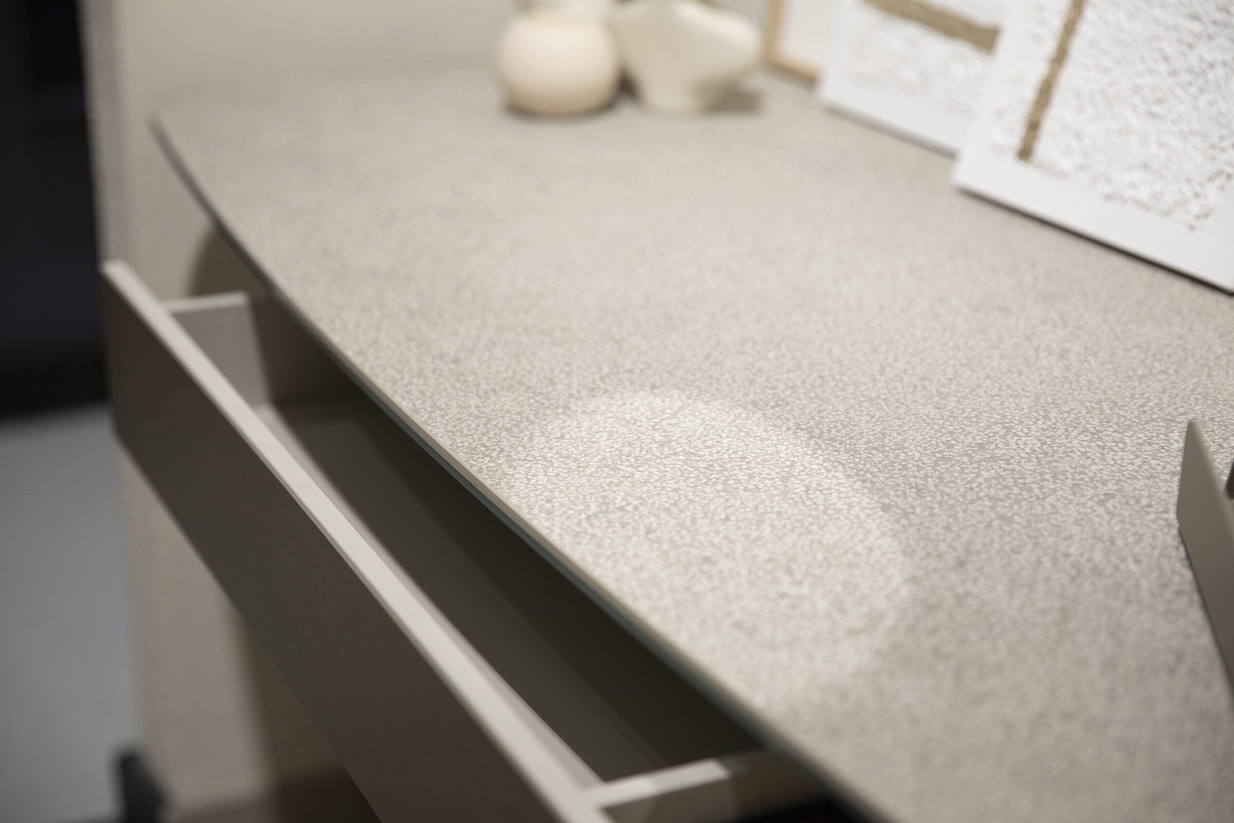 Sleek beige textured tabletop with white storage drawer, modern furniture design, ideal for stylish living or office space, showcasing high-quality Saloni Furniture craftsmanship and elegant finishes.