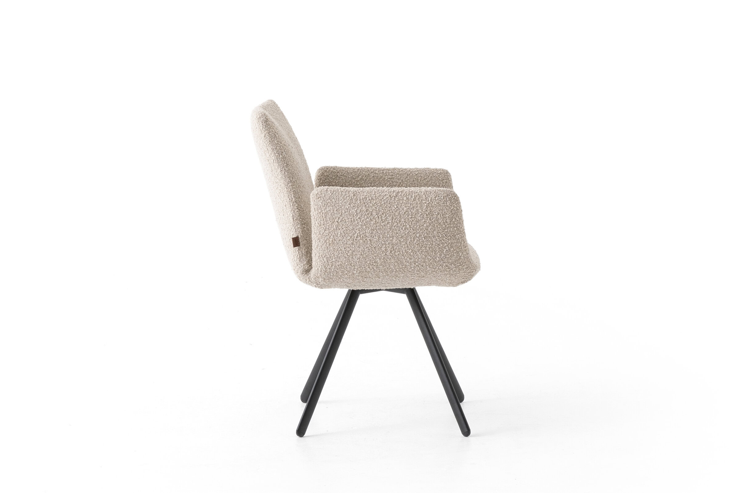 Elegant beige upholstered armchair with black angled legs, perfect for contemporary living room decor and comfort.