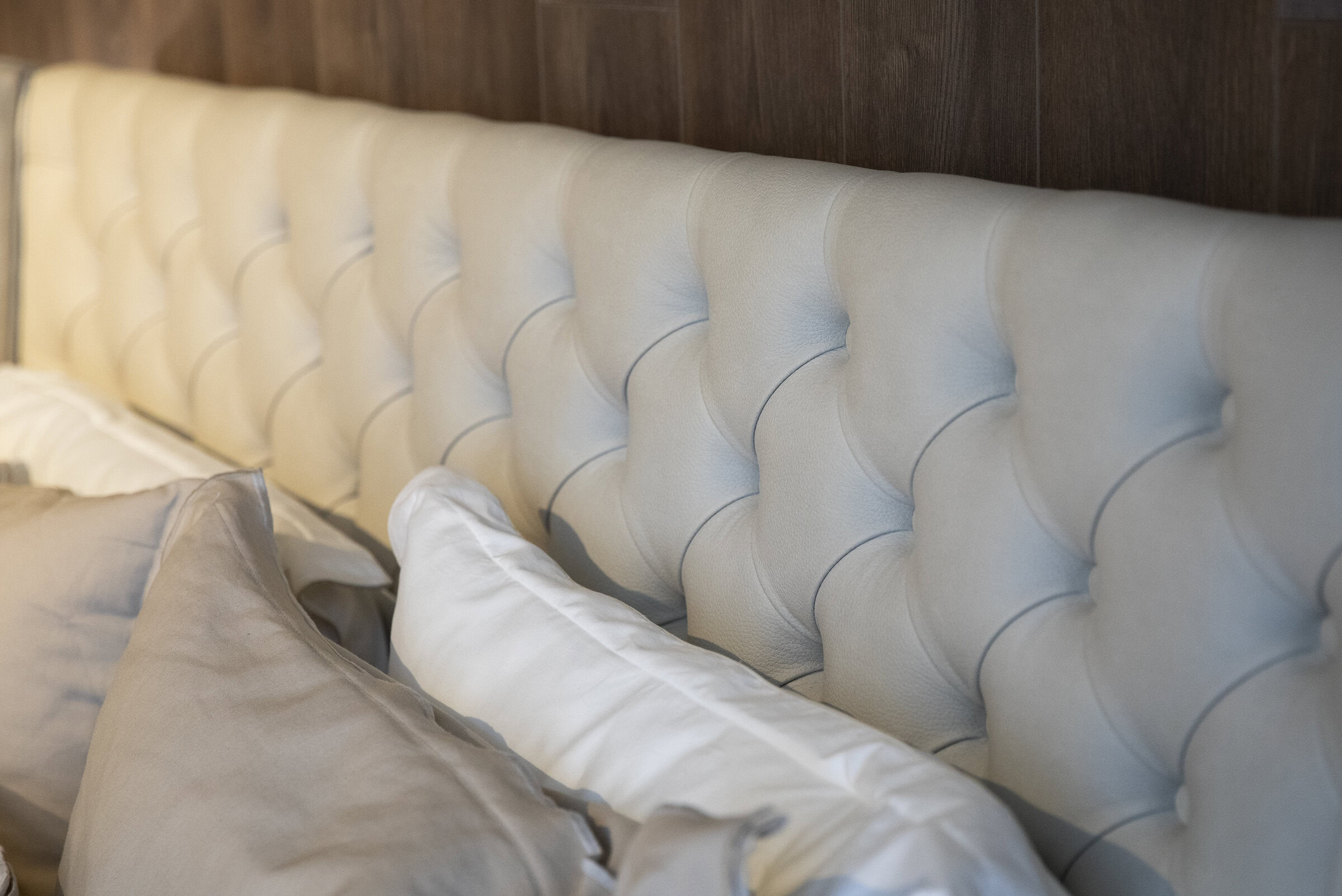 Luxurious upholstered bed headboard with elegant tufted design, custom-made for a cozy and stylish bedroom decor. Perfect for adding sophistication to your living space.