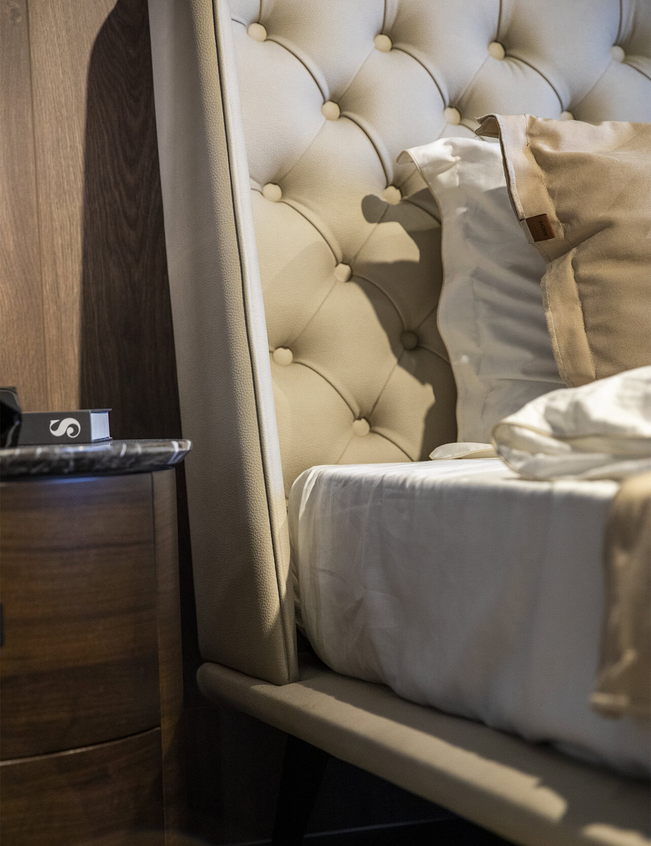 Soft beige upholstered bed with tufted headboard and elegant design, perfect for modern bedroom decor. High-quality furniture from Saloni Furniture offers comfort and style for your home.