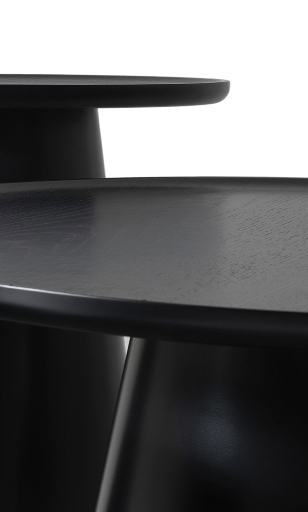 Minimalist black coffee table with smooth wooden surface and sleek design for modern interior decor.